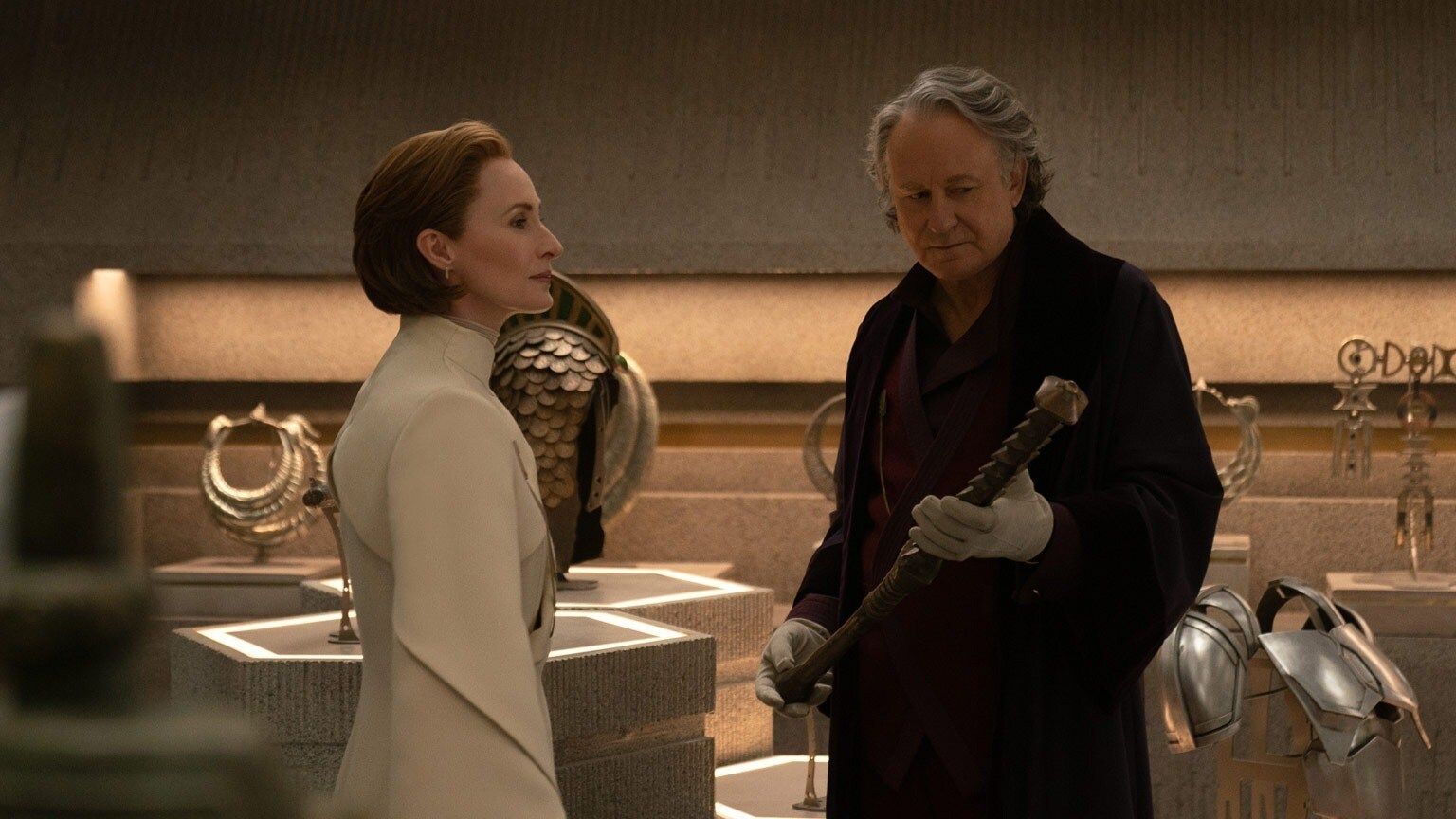 A scene from episode four. Mon Mothma (left) and Luthen (right) covertly discuss the Rebellion's shaky financial situation. The Mandalorian armor can be seen in the bottom right.